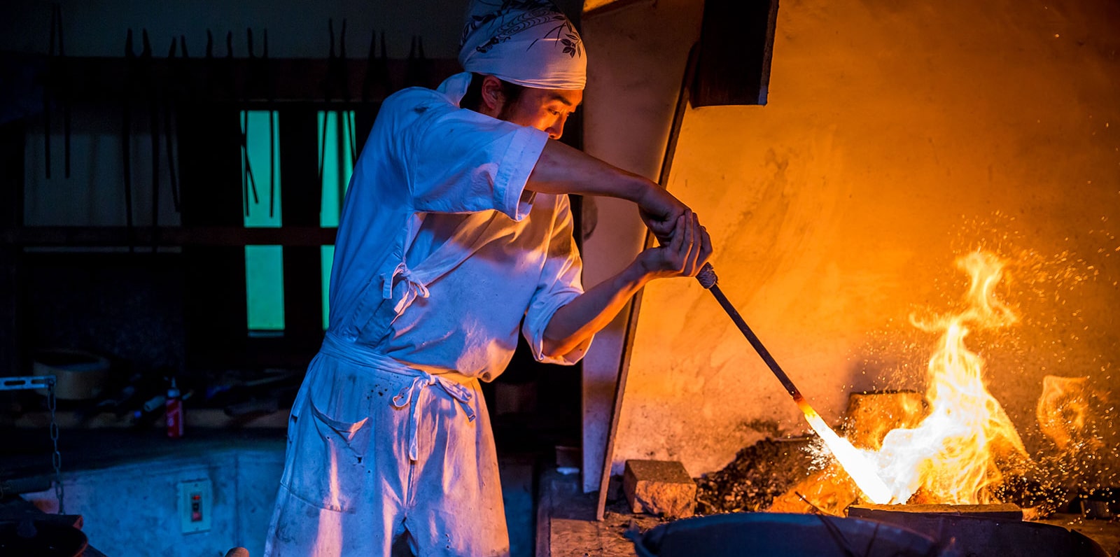 Artisan forging a katana blade by hand