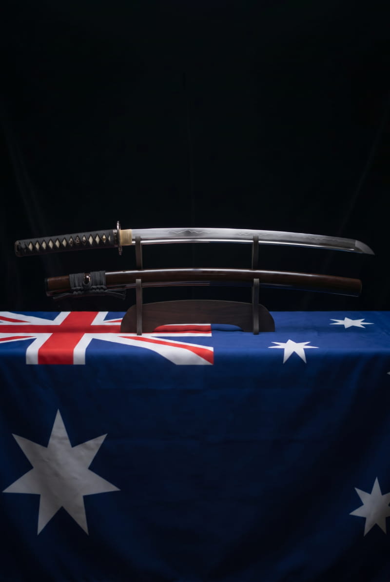Katana displayed in front of the Australian flag